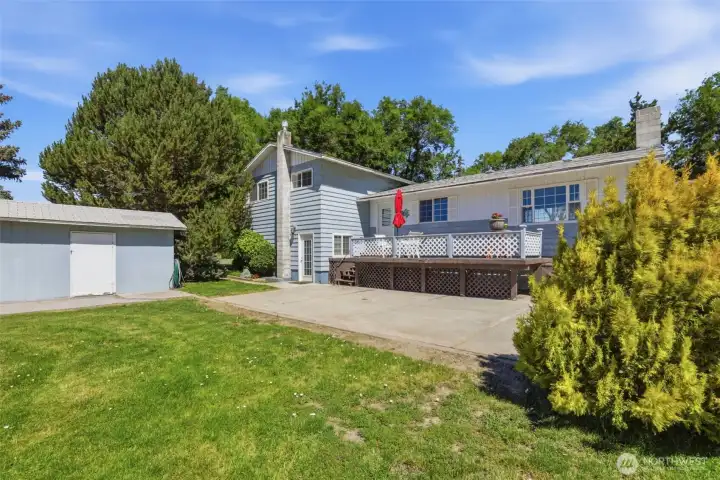 Photo of the back of the home with one of many outbuildings. There is a large deck and patio to enjoy the outdoors to it's fullest. Photo of the back of the home with one of many outbuildings. There is a large deck and patio to enjoy the outdoors to it's fullest.