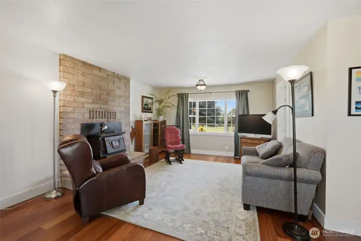 A view of the living room with beautiful hardwood floors, & large windows to allow for a lot of natural light. A view of the living room with beautiful hardwood floors, & large windows to allow for a lot of natural light.