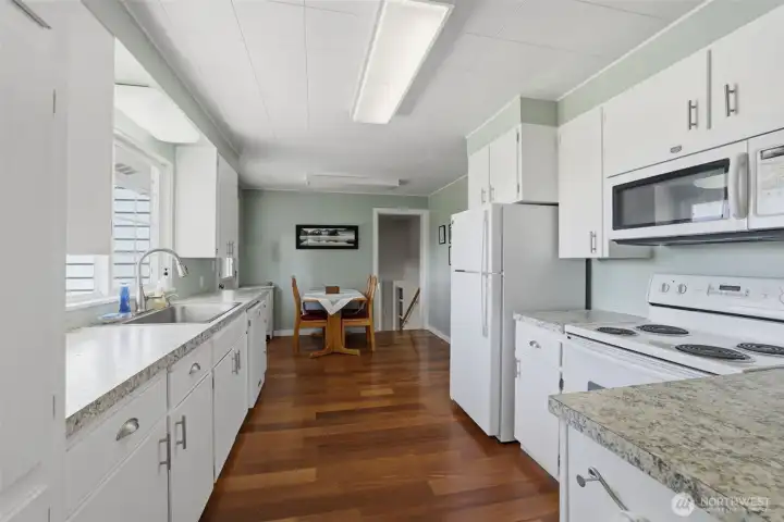 Here is a view of the kitchen looking of to the left as you enter the kitchen. You can see the stair well to downstairs it right there too. Here is a view of the kitchen looking of to the left as you enter the kitchen. You can see the stair well to downstairs it right there too.