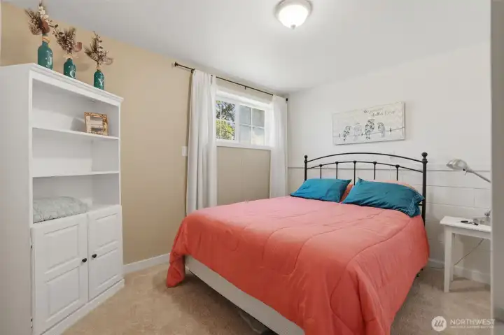 A photo of the lower level bedroom. Next to it is the 3/4 bathroom. A photo of the lower level bedroom. Next to it is the 3/4 bathroom.