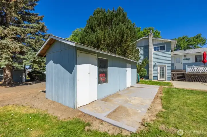 A view of the back yard deck & large patio. Also a view of an outbuilding. A view of the back yard deck & large patio. Also a view of an outbuilding.