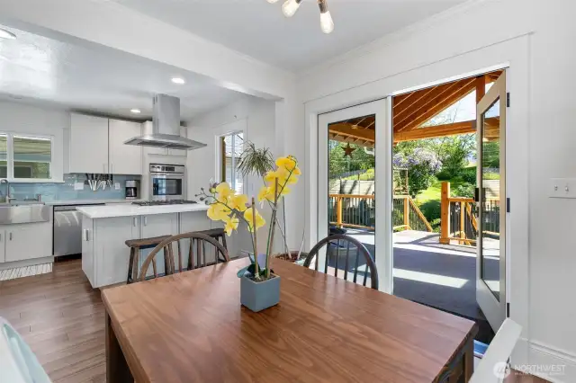 Glass French doors off dining room open to gorgeous plush back yard