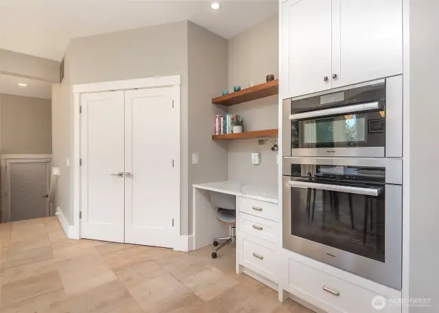 The command center in the great room offers a functional workspace, while the well-appointed pantry is a must-see, designed for both style and practicality.