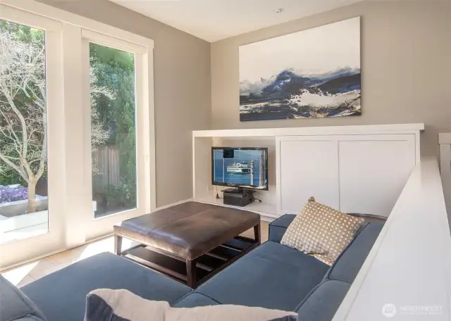Thoughtful touches include a sliding cabinet that hides the TV, preserving clean lines and a minimalist look when it’s not in use.