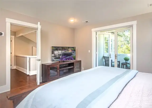 The primary bedroom features a spacious walk-in closet complete with a washer and dryer that stay with the home—a convenient and luxurious touch for everyday living.