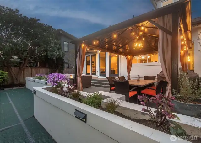 Outdoor living is enhanced with custom built-in planter boxes, a sprinkler system for easy maintenance, and yard lighting that sets the perfect ambiance for evening gatherings or quiet nights at home.