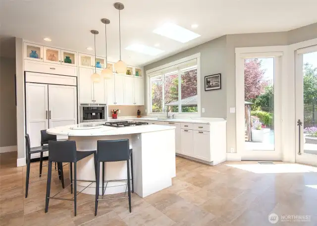 The island kitchen is a chef’s dream, featuring sleek Coretta marble countertops and top-of-the-line Miele appliances, including a built-in latte maker for your morning espresso fix.