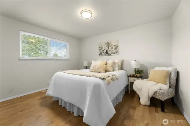 Primary bedroom with hardwood floors