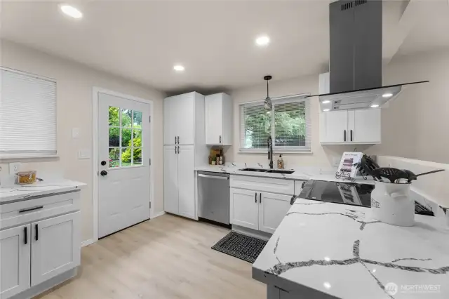 Bright kitchen leads to patio and yard