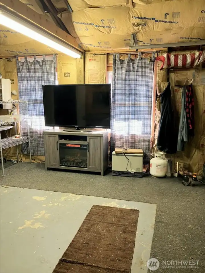 Inside the shop view of TV/open area.