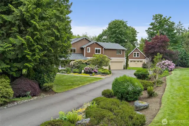 Drive up and admire your manicured mature landscape with sprinkler system!