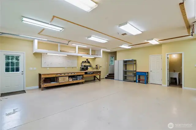 Your dream shop with huge bay and work benches. Radial Arm Saw stays with property.