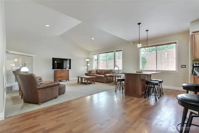 Vaulted living room. Large granite built-in table with storage underneath. Stools can remain with the home.