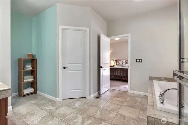 Bath room off primary with large closet and ceramic tile flooring.