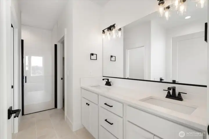 Primary ensuite with dual sinks, walk in shower and soaking tub.