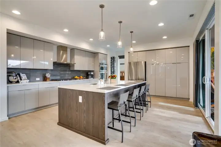 Stunning show-stopping kitchen-quartz island fit for a dinner party, pendants that look hand-blown, and cabinet faces so perfectly lacquered you could see your dreams reflected in them.
