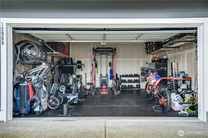 Wired for a Generator and Installed Electric Charging unit ready to go.  Additional garage prep-sink and tons of storage.
