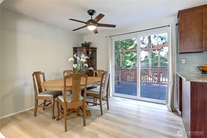 Upper level dining room off kitchen leading to back yard deck for sunny entertaining.