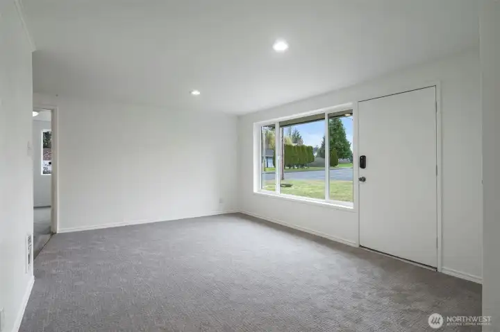 Without the virtual staging. Lots of options for different layouts. The hallway in the background leads to the bedroom that is off the driveway, great for a home office or guest room.