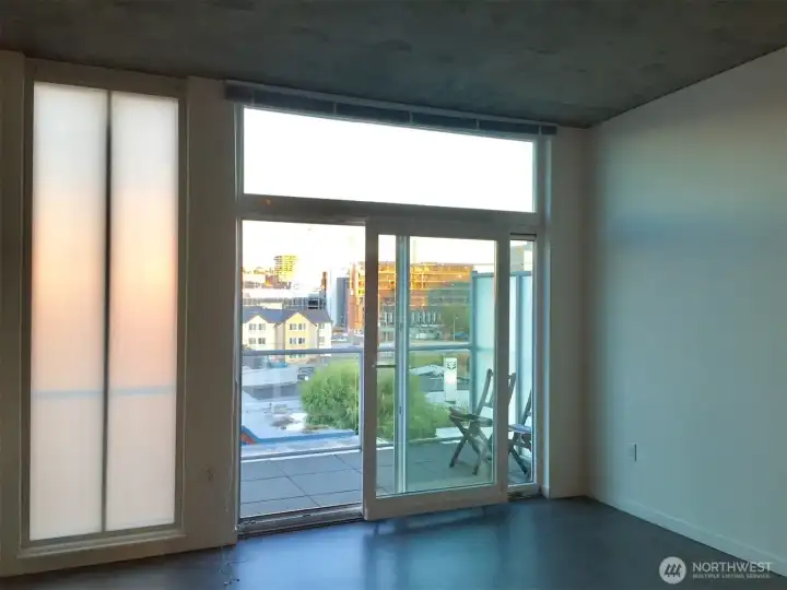 Towering floor to ceiling windows and sliding door.