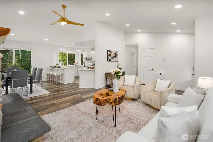 The generous living area flows effortlessly toward the backyard, with a ceiling fan, recessed lighting, and an abundance of natural light creating a comfortable, versatile space perfect for both everyday living and entertaining.