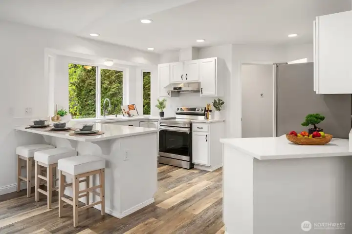 The crisp white kitchen shines with quartz countertops, newer appliances, and a welcoming island with bar seating, all bathed in natural light that pours in from the windows overlooking the beautifully landscaped backyard.