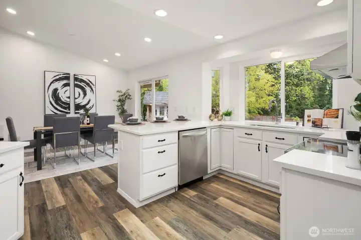 A versatile utility room off the main living area offers excellent additional storage and workspace, with the same fresh white cabinetry and bamboo flooring that carry throughout this beautifully updated home.