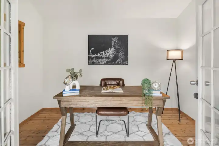 The bright and inviting interior of the outbuilding office features a clean, minimalist aesthetic with warm natural light and French doors, making it an ideal private workspace, creative studio, or guest retreat completely separate from the main house.