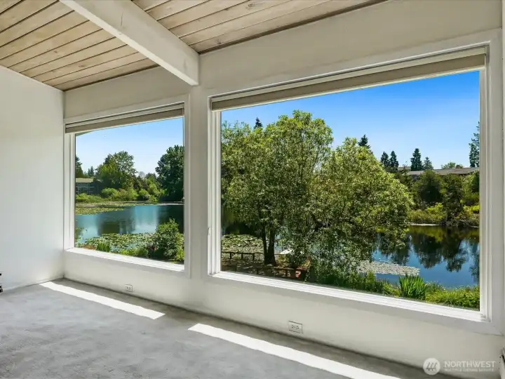 Large windows in the living room to showcase the lake view Large windows in the living room to showcase the lake view