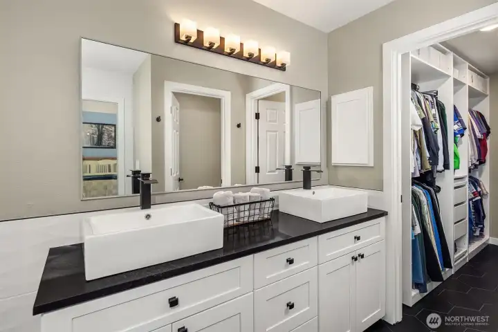 A dual vanity with plenty of storage, along with a water closet. A dual vanity with plenty of storage, along with a water closet.