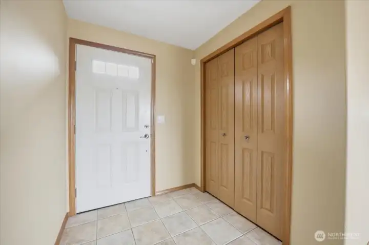 Front door entry with coat closet.