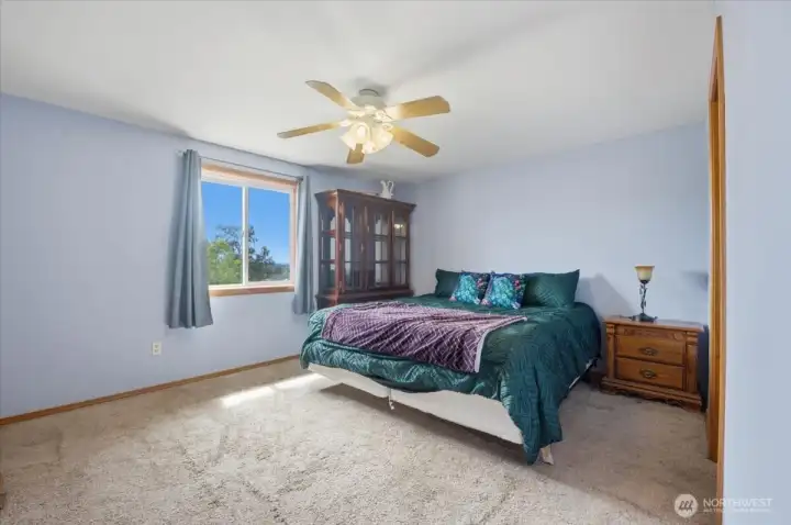 Primary bedroom with eastern sunset views.