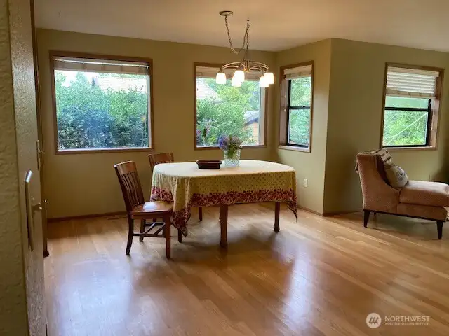 Walk into the open living room, dining room area with oak flooring.