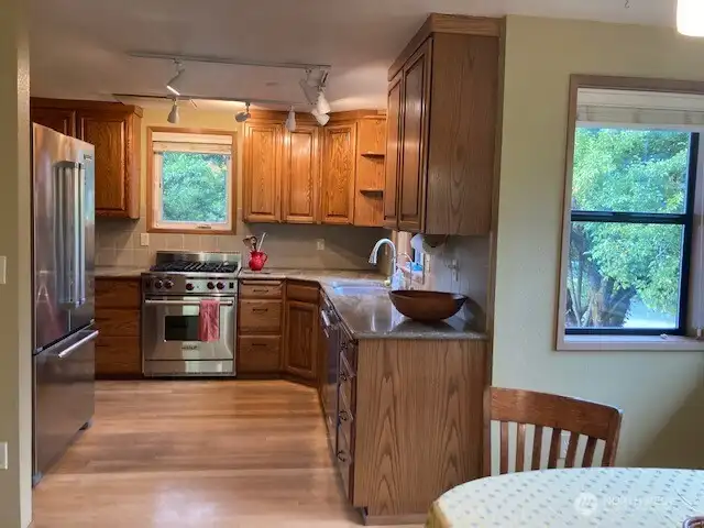 from the dining area the view of the kitchen with the Wolf gas free standing stove.