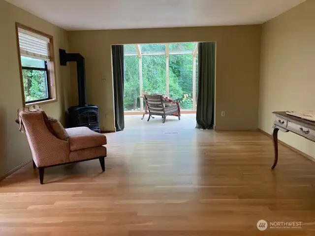 The large living room area looking from the kitchen to through the living room to the sun room.