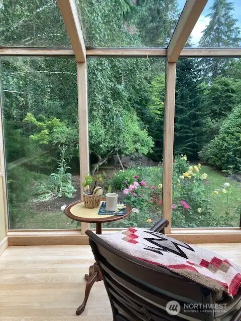 Relax with a full view of the rose garden and back yard.