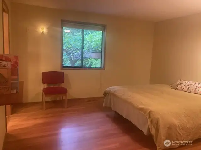 Primary bedroom with window facing the lovely backyard.