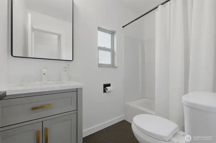 Full bathroom with new vanity, toilet and flooring Full bathroom with new vanity, toilet and flooring