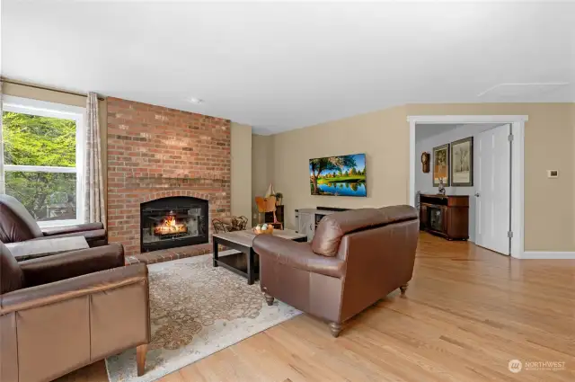 The family room is located just off the kitchen and includes hardwood floors and wood-burning fireplace.  The double doors lead into the den/office.
