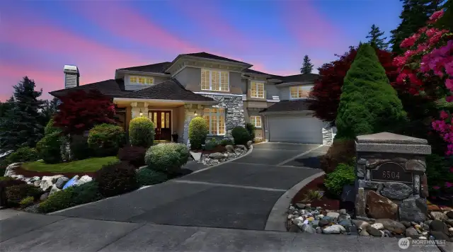 Refined landscaping and stonework details make for impressive curb appeal
