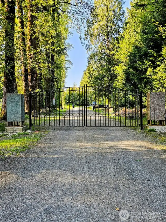 A striking front entry gate sets the stage for privacy and presence—currently in progress and ready for your personal touch. Buyers will have the unique opportunity to select the stonework for the gate’s columns, allowing you to shape the entry to reflect your style and elevate curb appeal.