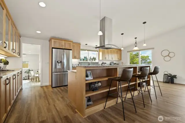 The kitchen is a chef's dream, with ample storage and counter space, attractive appliances and custom red birch cabinetry.