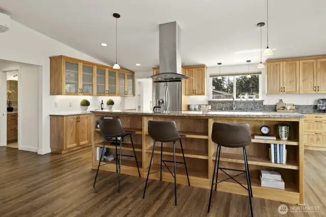 A counter spot for a quick meal or snack,  or for your guests to sit/stand and visit with you while you cook.  Built in shelving/book case below makes brilliant use of the space