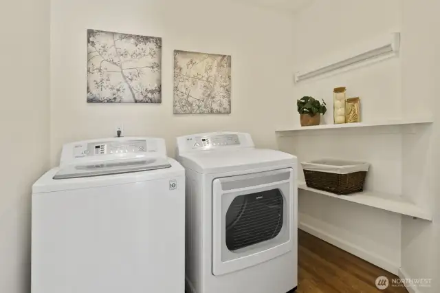 Laundry room includes shelving and a pull out/folding drying rack for your air dry items