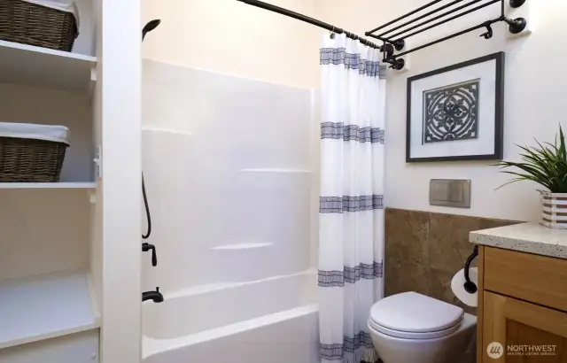 Shower over tub, and a Toto toilet with great storage - what's not to love?