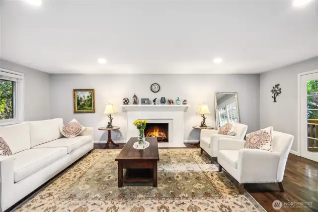 Beautiful and warm living room with hardwood flooring, refined fireplace surround and tons of natural light.