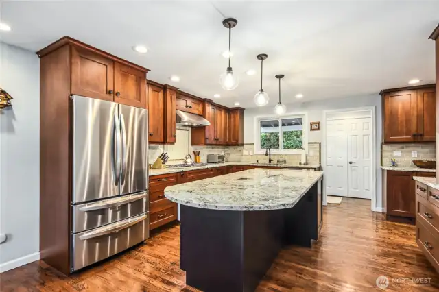 Breathtaking Chef's kitchen with expansive counters, luxurious appliances and custom cabinetry is the perfect place to host guests.