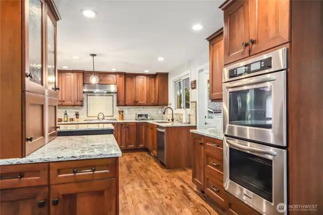 Tons of custom cabinet storage and double oven is a focal point of this stunning Chef's kitchen.
