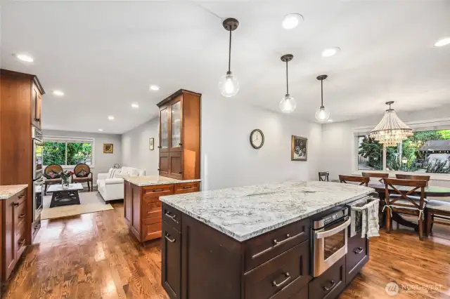 Kitchen features designer lighting, hardwood flooring and moves seamlessly into the great room offering an open layout.