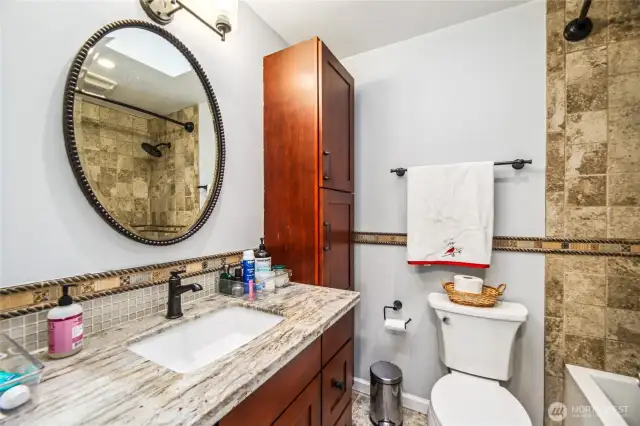 Full guest bathroom located on upper with new paint and warm, neutral tone finishes.
